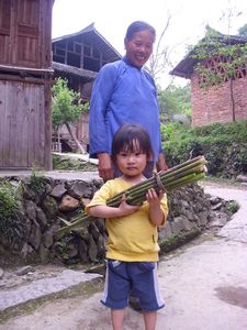 Little girl with her grandma collecting bamboo