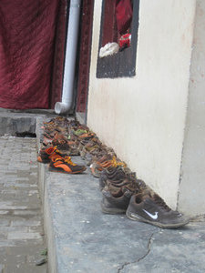 Children monks' shoes outside the school