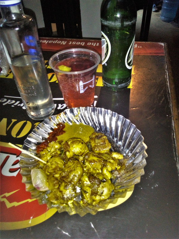 Buffalo brains, raksi and Mountain Dew, a marriage made in heaven. Note the slither of raw beetroot in the raksi...