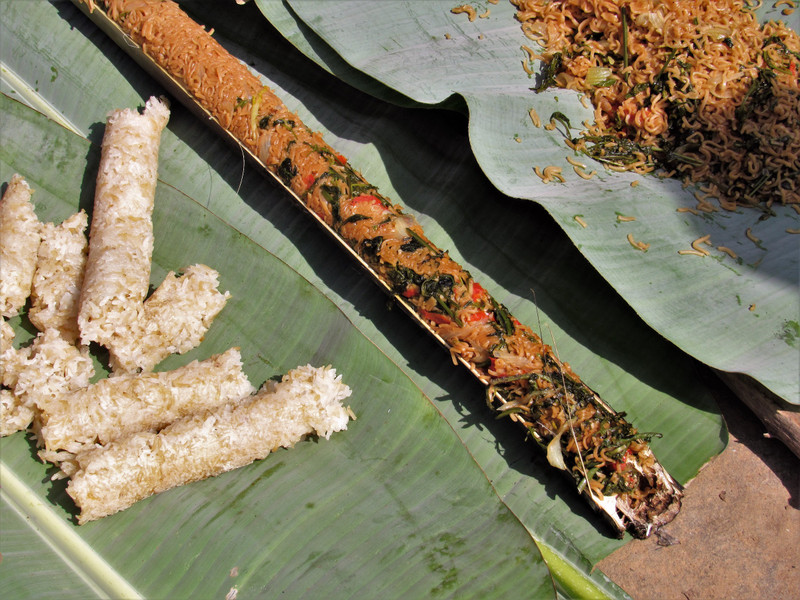 Sticky rice and spicy noodles cooked within bamboo