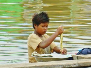 Boy washing clothes in Ayeyarwady river