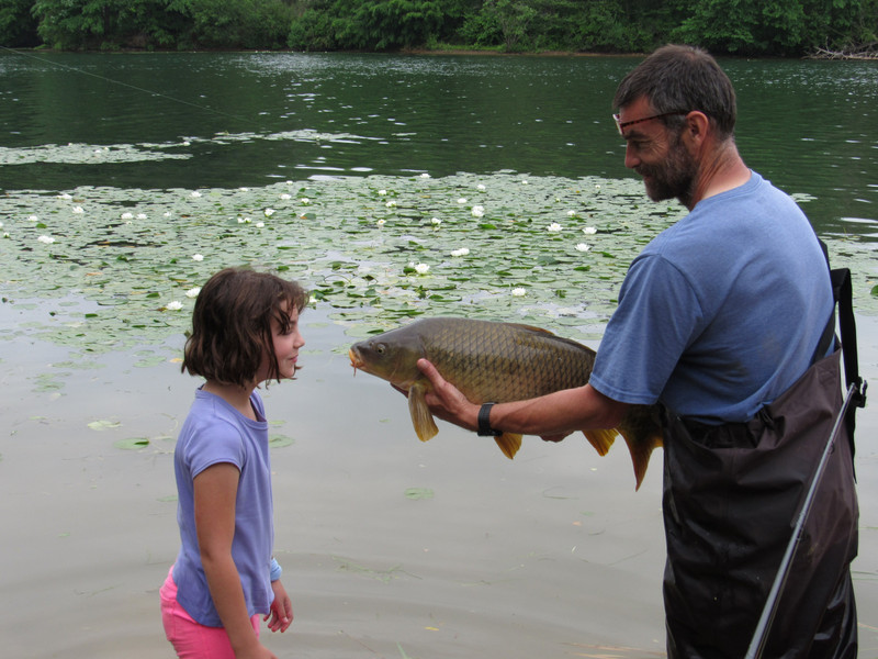 Father and daughter bond over a fish