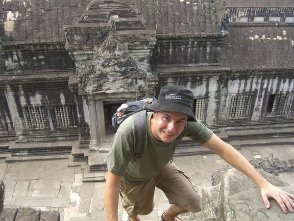Climbing the vertical stairs to the top of Angkor Wat