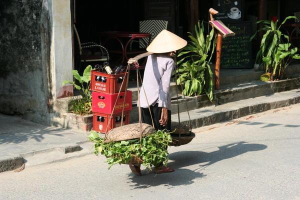 Woman Carrying Goods In Hoi An 