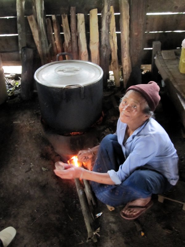 Old lady making laos laos- sticky rice whiskey.
