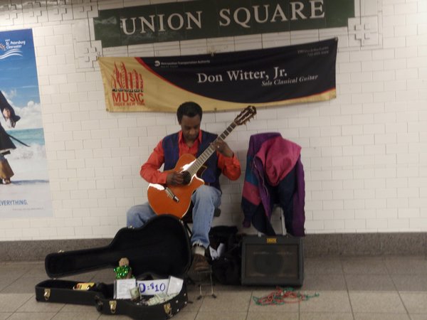 Guy jammin' out at the Union Square subway stop
