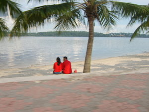 A local couple looking out over the Singapore Straights from Malaysia to Singapore island.