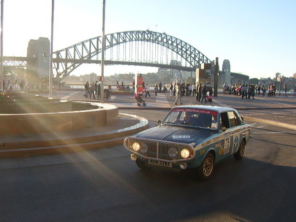Driving away from the Opera House with the Sydney bridge in the background.