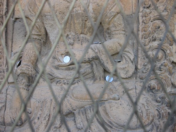 Detail of Buddha with coin offering