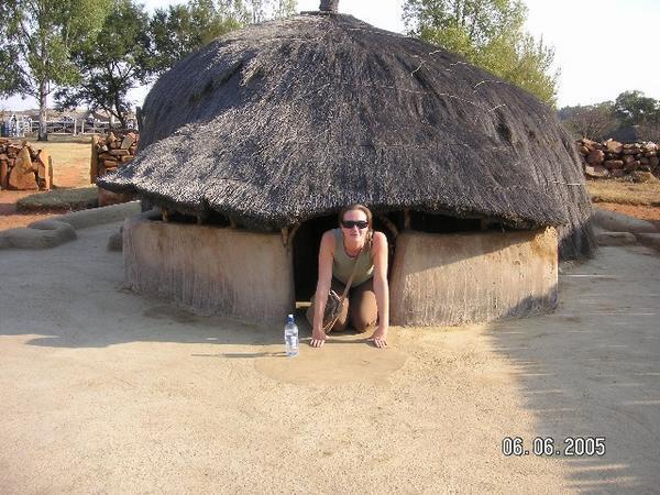 Me emerging from an african hut!