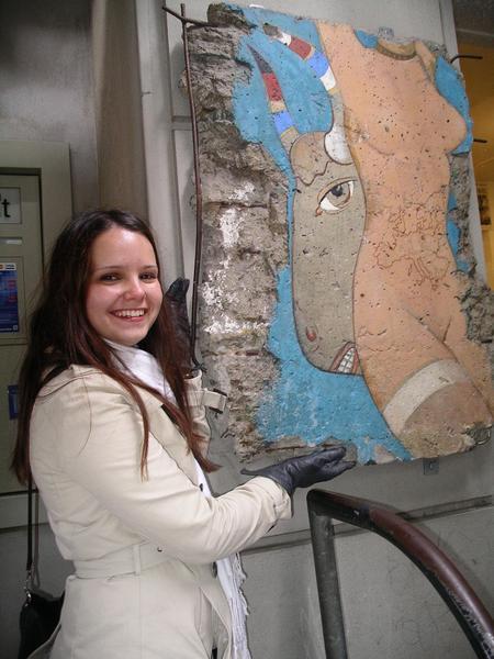Me with a piece of Berlin Wall at Checkpoint Charlie