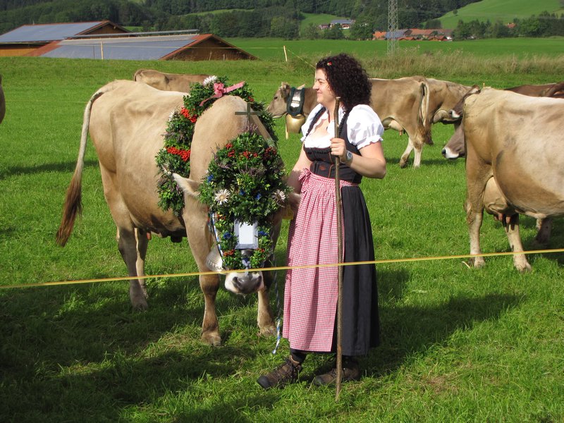A lead cow decorated with flowers and a cross