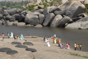 People washing at the river before entering the temple