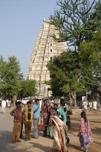 Chuckling locals in Hampi main street with temple behind
