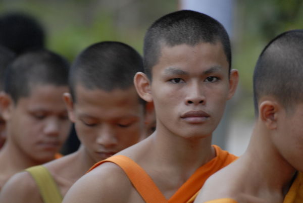 Novice monk waits in line for Alms...