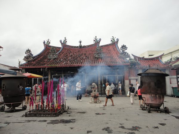 Temple with lots of people burning stuff