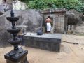 priest opens door to inner sanctum of village Shiva temple