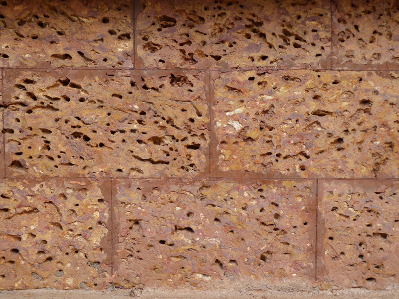 Laterite stone, showing its porosity and high iron oxide content giving it a red color