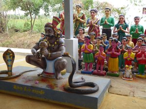 Snake Charmer and Onlookers at a Temple Beside the Road