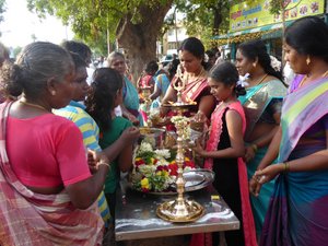 Family distributes sweet pongal blessed by the deity