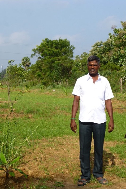 Muthu, very proud of his "farm"