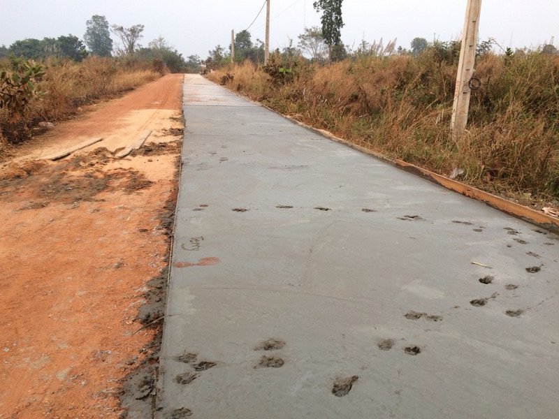 Concrete road under construction, footprints