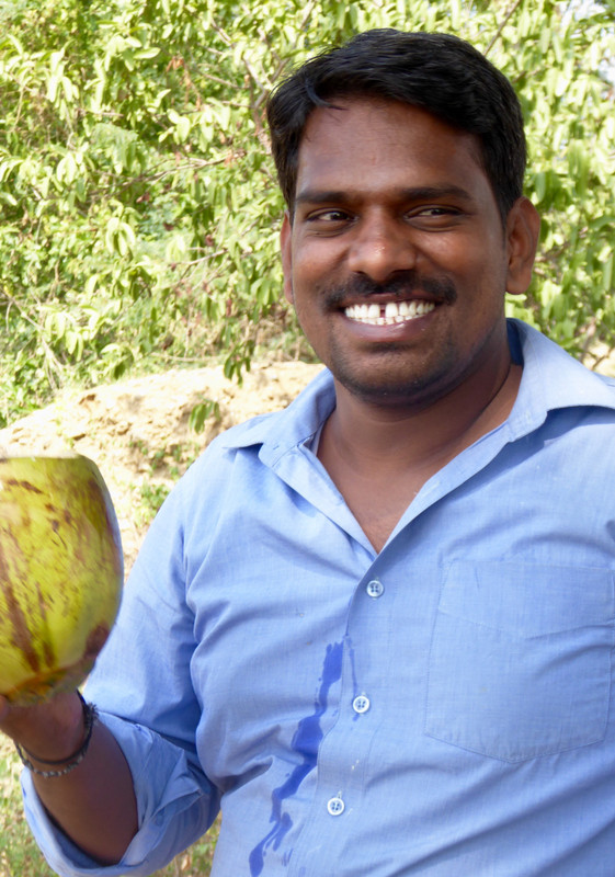 Karikalan and coconut (water down his shirt)