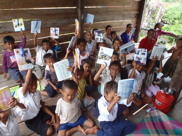 Kids proudly displaying their new notebooks & pens