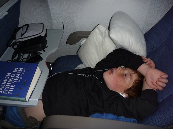 Lachie demonstrating how to sleep on a plane!