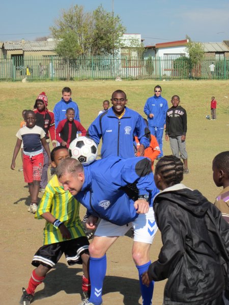 Playing with kids at coaching clinic in Soweto