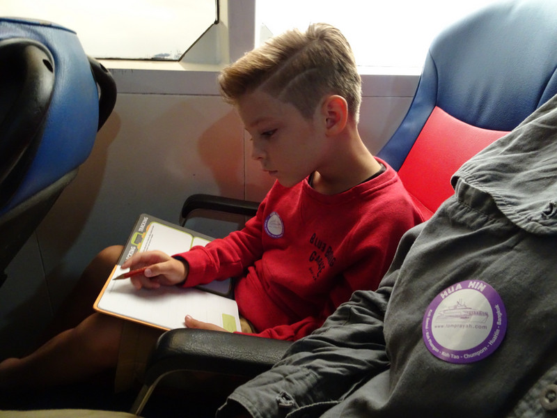 Mali doing his homework on the ferry across to mainland Thailand