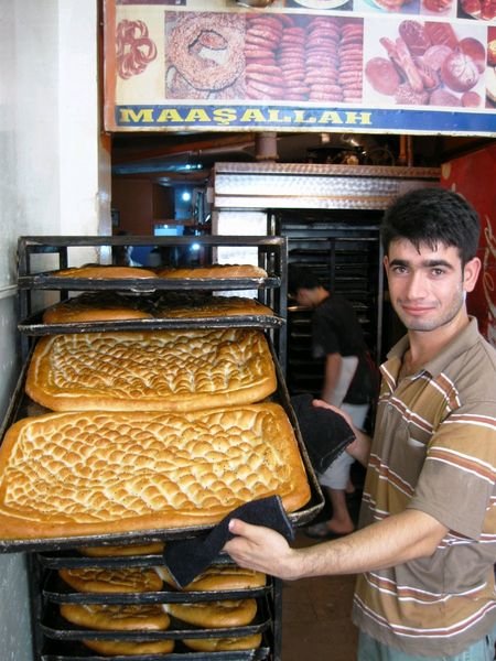 Baker with  fresh loafs just before the end of Ramadan (too bad we cannot record the smell)
