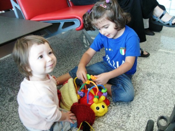 Liya making friends at the airport between flights 