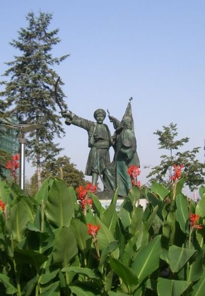 Statue and Red Flowers
