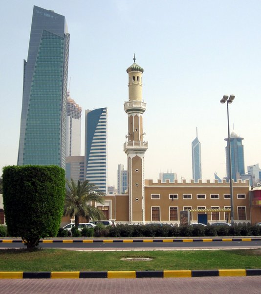 A mosque overlooked by the skyscrapers of downtown Kuwait City