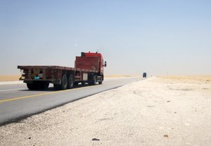 A truck speeds past, Saudi Arabia