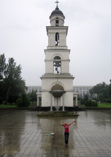 A girl doing a rain dance in front of the Bell Twoer