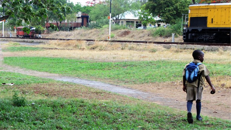 A young boy approaches the train tracks