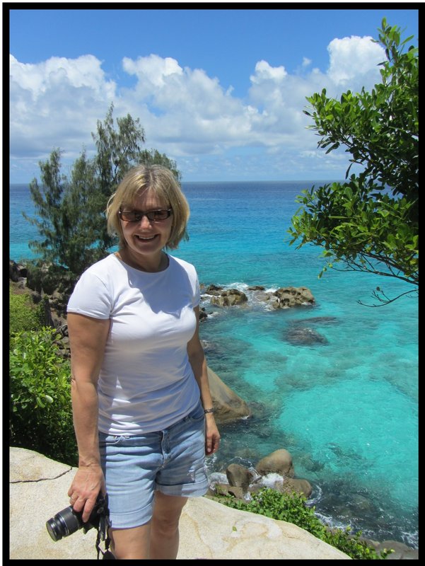 Angela poses besides the seaside