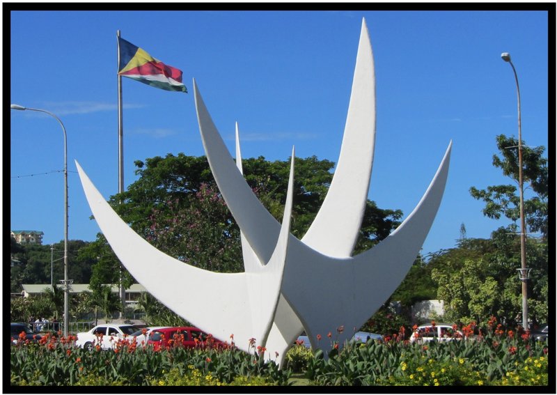 Three Birds Sculpture Roundabout, with a Seychelles flag in the background