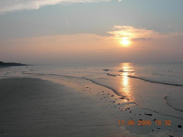 Sun setting across a north Norfolk beach