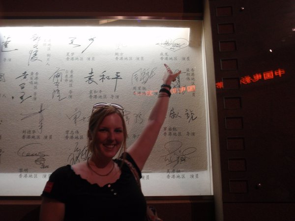 pointing to Jackie Chan's signature