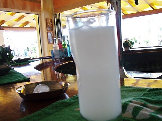 A wobbly glass to drink ouzo