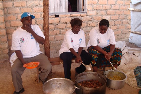 UNHCR staff assisting with the food on World Refugee Day