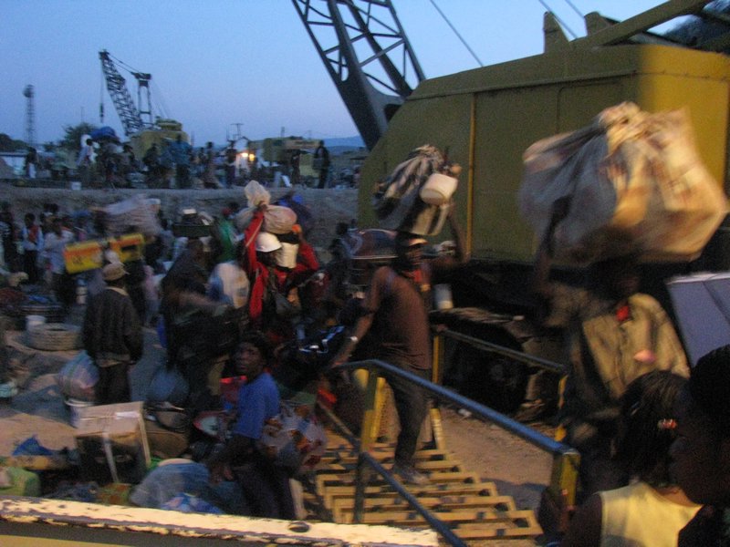 Refugees load their luggage