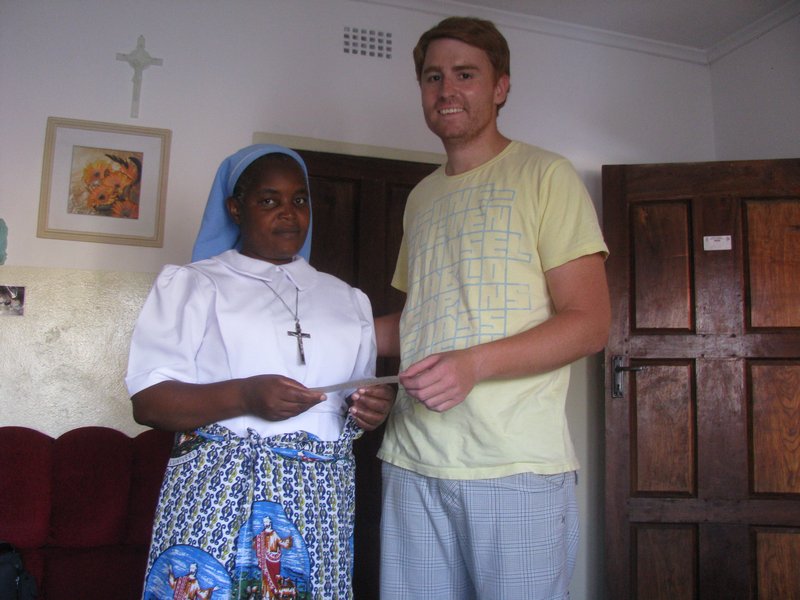 I present sister Katonkola of Kawambwa orphanage with the donation cheque