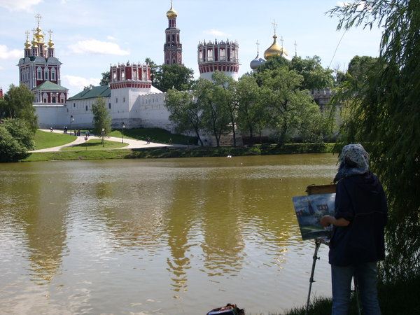 Woman painting a monastery