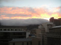 CLouds and sun setting over Table Mountain. Outside our flat window