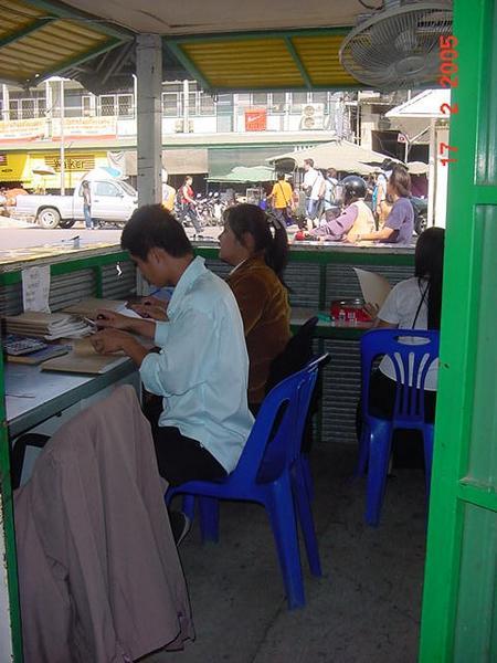 Officials stamping visas at the Myanmar - Thai boarder