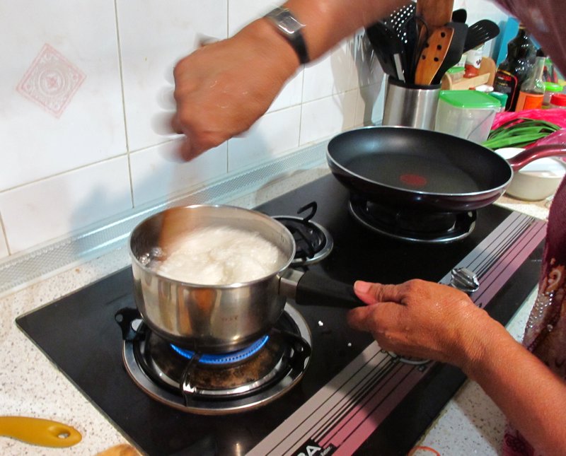 Fatimah Stirring the Sago in Boiling Water as it Expands